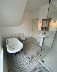 A new bathroom wet room installation featuring a free-standing bath, walk-in shower, new sink and WC.