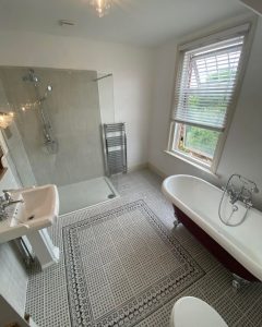 A new bathroom wet room installation featuring a free-standing bath, walk-in shower, new sink and WC.